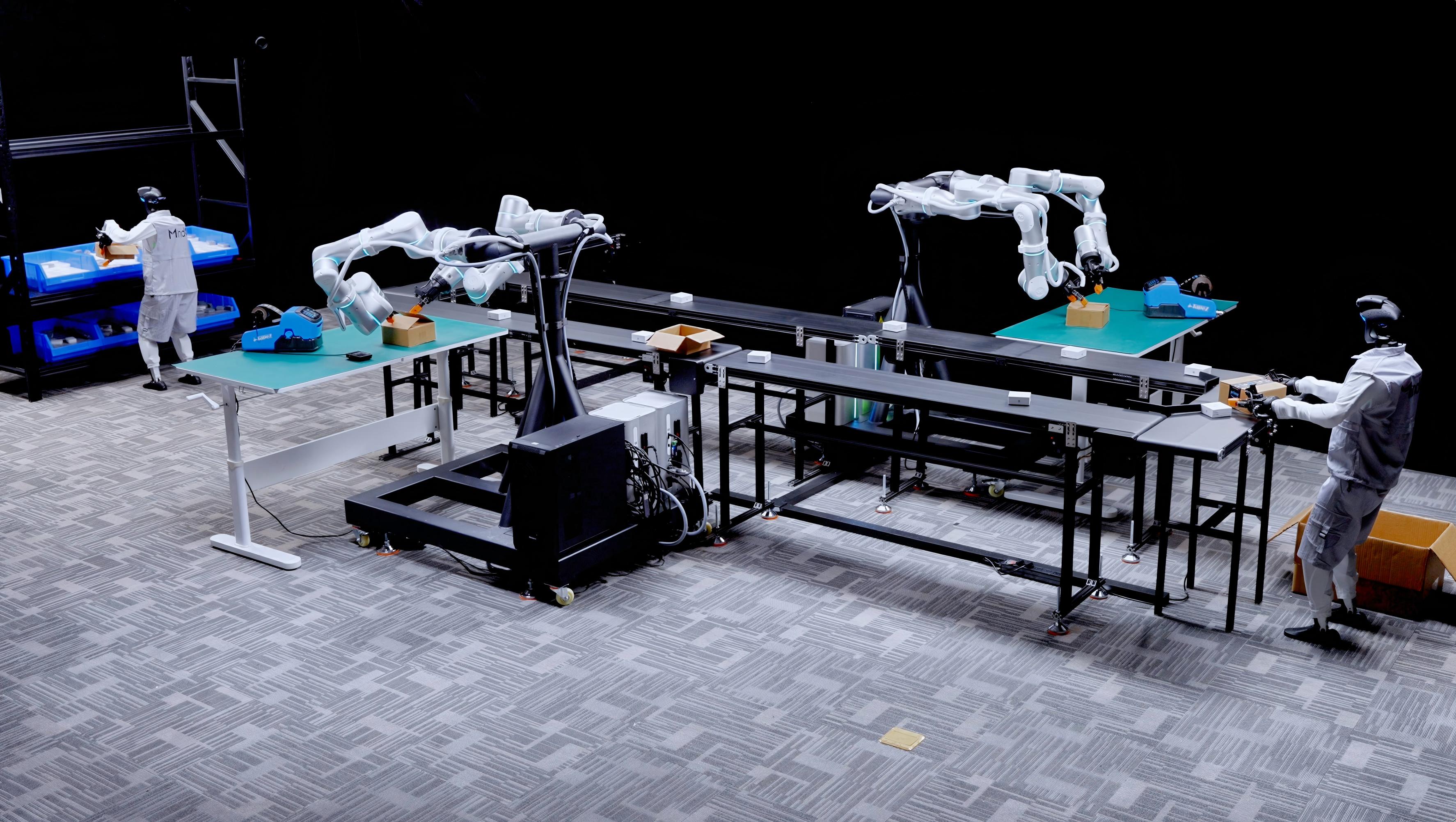 Researchers and robotic arms in a human-centric data collection lab